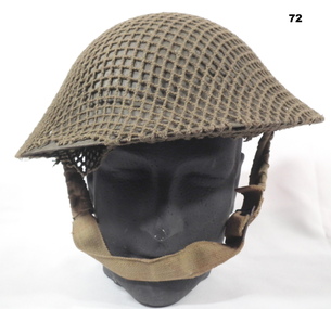 British pattern steel helmet covered with camouflage netting.