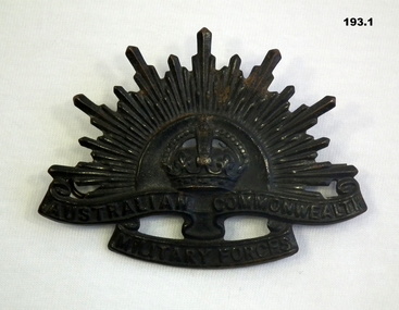 Blackened Rising Sun hat badge WW2
