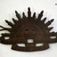 Blackened metal Rising Sun hat badge