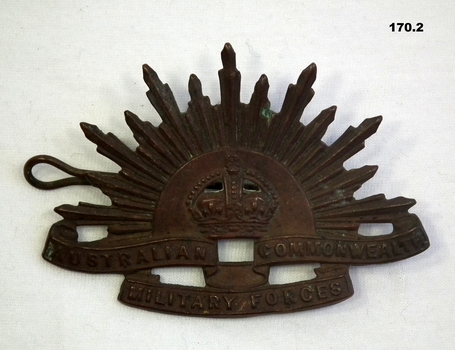 Blackened metal Rising Sun hat badge