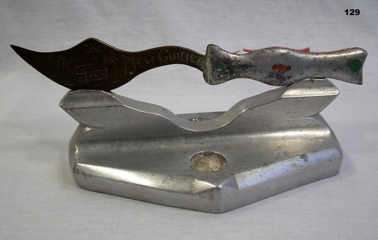Metal souvenir dagger and base from New Guinea