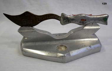 Metal souvenir dagger and base from New Guinea