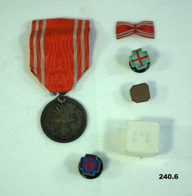 Japanese member of the Empire Red Cross and rosettes.