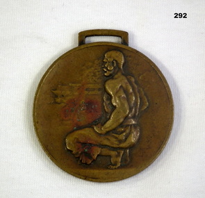 Circular medal wth squatting man