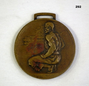 Circular medal wth squatting man