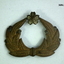 Small gold coloured badge with wreath