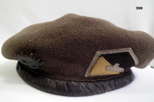 Khaki beret with armoured Corp badge.