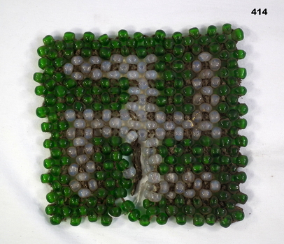 Trivet made from beads to make a Swastika