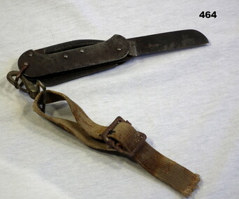 Utility knife with webbing strap attached