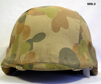 Helmet with jungle pattern material covering.