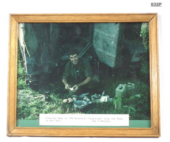Photograph showing a trooper in Vietnam cooking