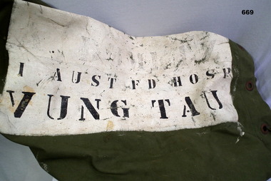 Kit bag painted white with black lettering