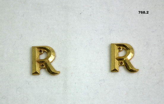 Letter “R” badges denoting retired officer