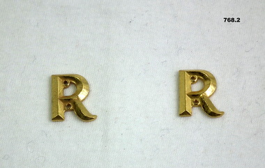 Letter “R” badges denoting retired officer