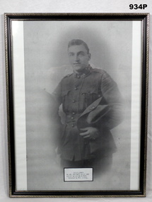 B & W photo of a soldier holding slouch hat