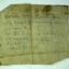 Small piece of cloth with hand written text