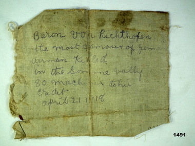Small piece of cloth with hand written text
