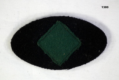 Oval colour patch with green diamond shape in centre
