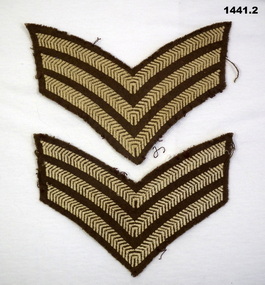 Two khaki coloured Sergeants arm rank patches.