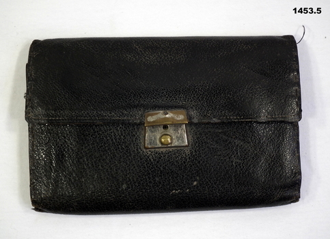 Black leather wallet with note book & articles.