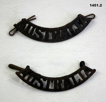 Two curved Australia shoulder badges.