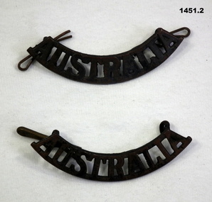Two curved Australia shoulder badges.