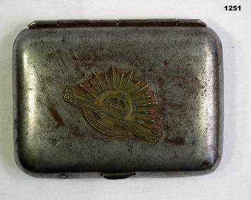 Metal cigarette case with Rising Sun badge