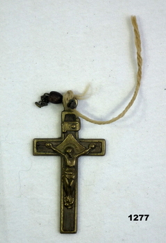 Small brass religious crucifix with cord