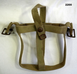 Khaki webbing and metal water bottle carrier.