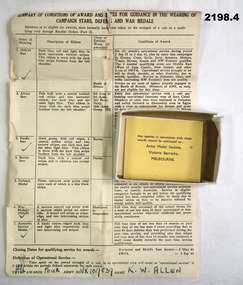 Medal boxes with explanation paper re medals
