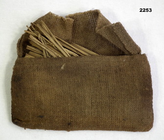 Khaki colour. Cloth bag with fine fibres in.
