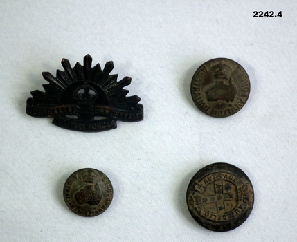 Three uniform and one rising sun lapel badge.