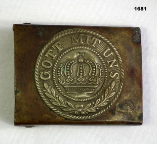 Metal German belt buckle with embossed text.