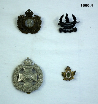 Four badges of differant British regiments.