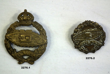 Two badges with depiction of a tank on.