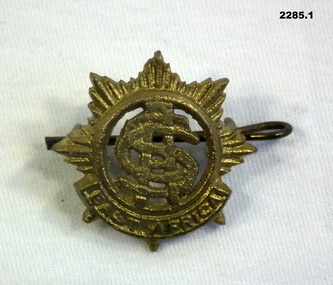 Five badges part of a wider collection.