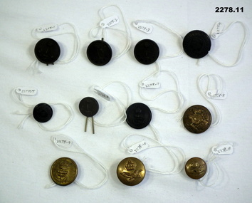 Eleven uniform buttons of different origin.