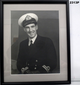 Black and white framed portrait of an RAN Officer.