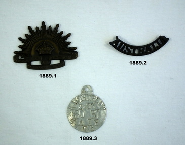 Two uniform badges and Identity disc WW2.