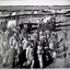 Photo shows a group of airmen with tiger moths in rear.