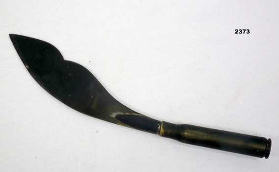 Trench art butter knife made from a cartridge.