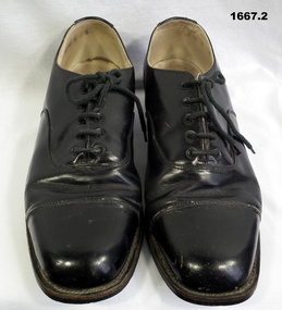 Pair of black lace up army issue shoes.