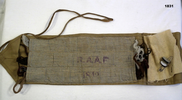 Shows the inside of a WW2 sewing kit.