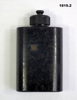 Black coloured Bakelite oil bottle.