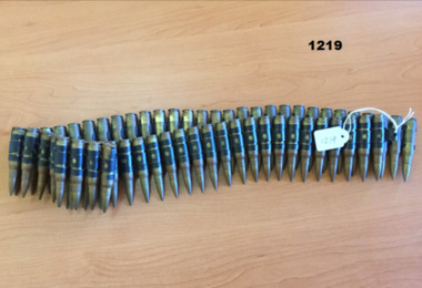 A link belt of 63 rounds of 7.62mm ammunition.