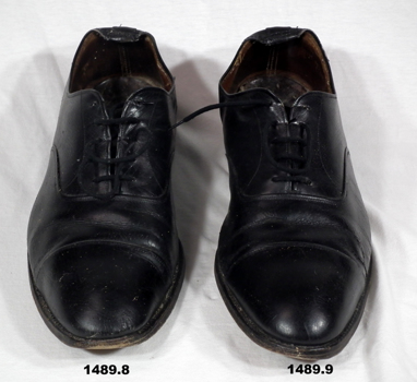 Uniform pair of black issue shoes.