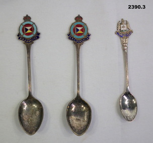 Three souvenir teaspoons of different places.