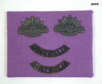 Two rising sun lapel & Australia badges on felt.