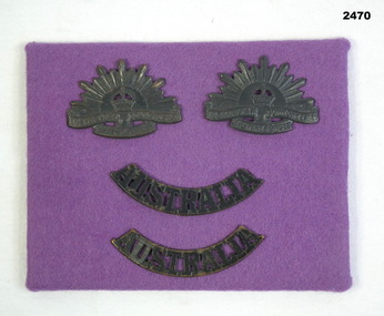 Two rising sun lapel & Australia badges on felt.