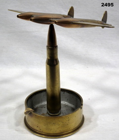 Trench art ash tray with model plane on.